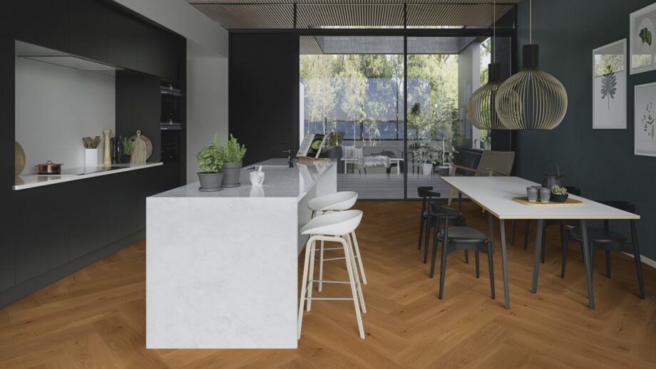 Herringbone flooring oak mix brushed bevelled oilwaxed 180mm – natural tone and lively grain variation highlighting the character of oak. Installed on a kitchen floor with kitchen furniture, kitchen island, dining table, and a view to the terrace.